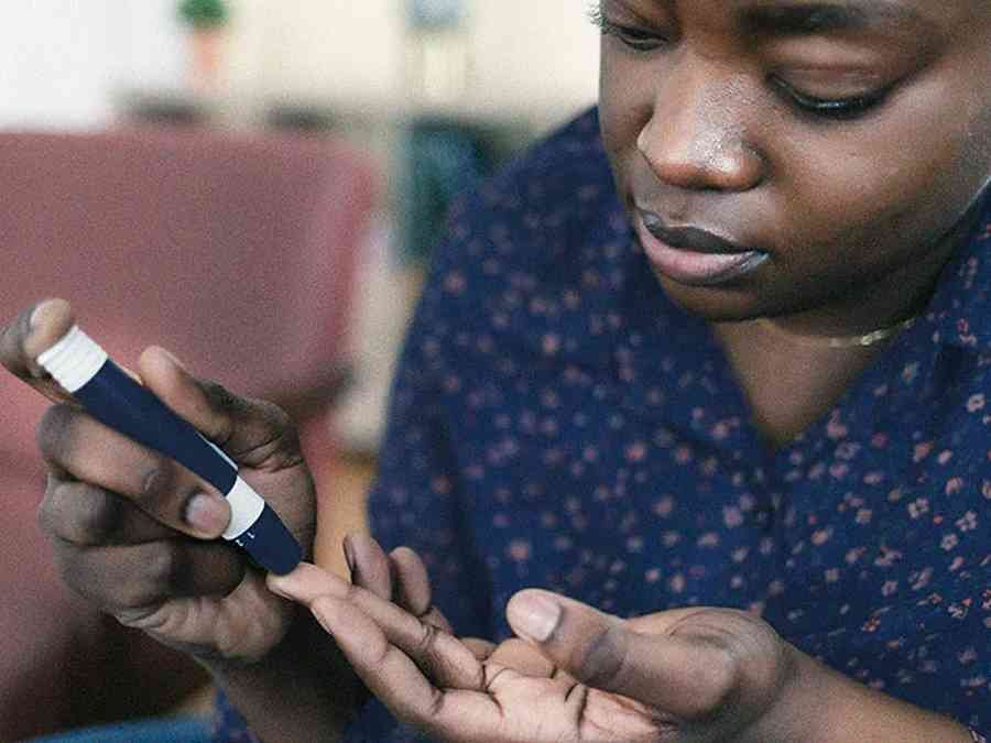 A woman checking her blood glucose