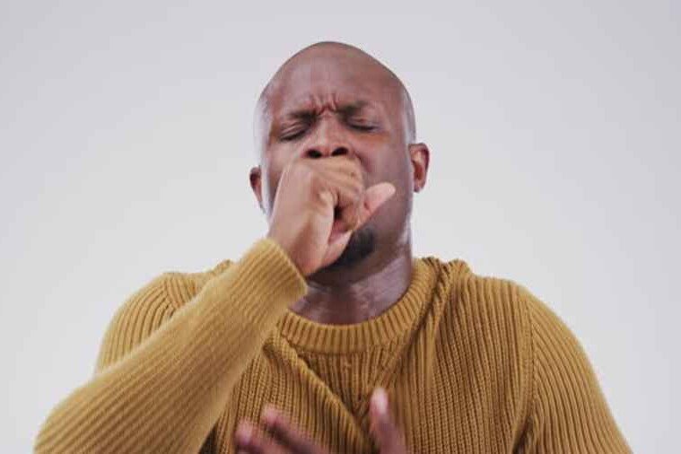 A man coughing